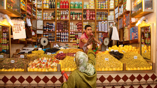 Shopkeeper and his customer in a souk (market) deep in Tangier's medina.