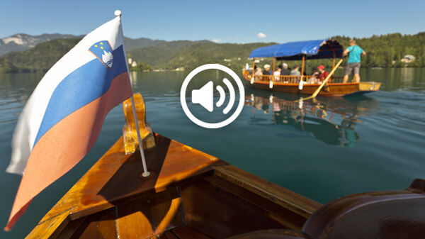 Boats and Slovenian flag on Lake Bled, Slovenia