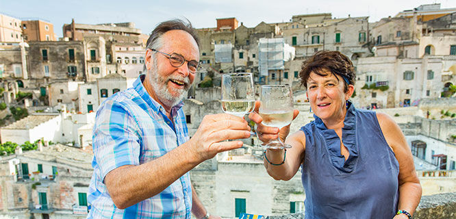 italy-matera-couple-toasting-on-balcony