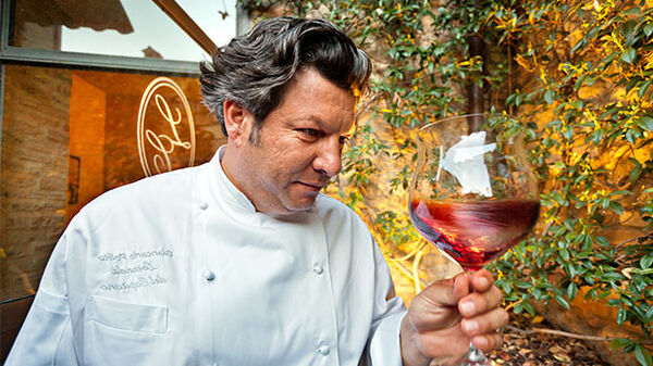 chef-swirling-wine-in-montefalco-italy