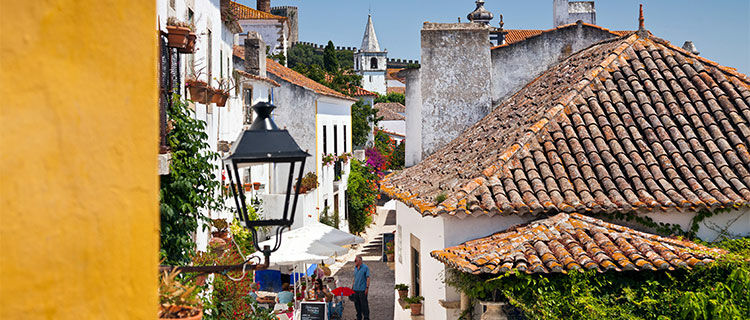 Charming street with rooftops and flowers, Obidos, Portugal