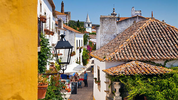 Charming street with rooftops and flowers, Obidos, Portugal