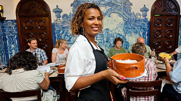 Server and tour group dinner, Portugal