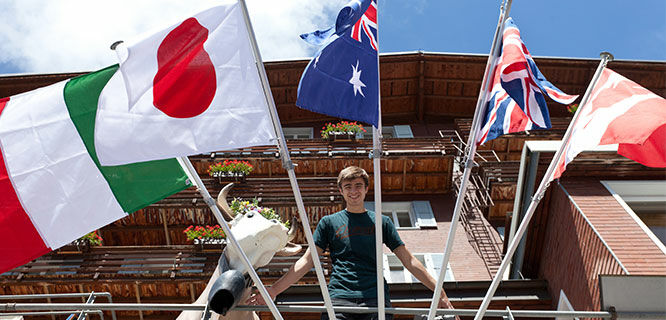 Guy on balcony with flags, Switzerland