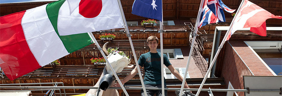 Guy on balcony with flags, Switzerland