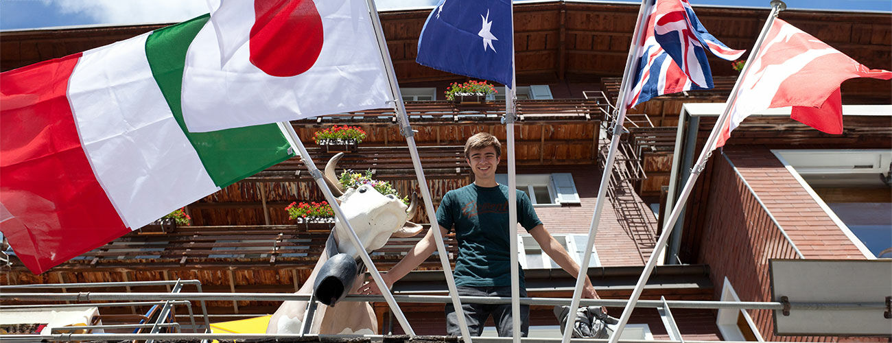 Guy on balcony with flags, Switzerland