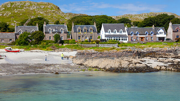 Row of stone houses along the shoreline of the isle of Iona, Scotland