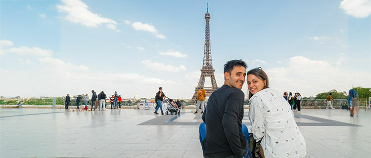 Young couple with Eiffel Tower, Paris, France