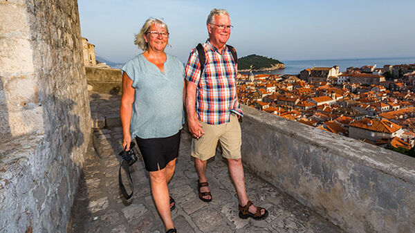 Couple walking the walls, Dubrovnik, Croatia