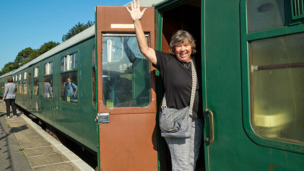 Lady waving from a train in England