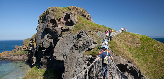 Walkers on Carrick-a-Rede rope bridge, County Antrim, Northern Ireland
