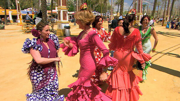 Ladies in fancy dress dancing at April Fair, Sevilla, Spain