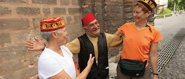 Two ladies with hat vendor, Istanbul, Turkey