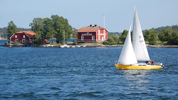 Sailboat and buildings on island, Stockholm Archipelago, Stockholm, Sweden