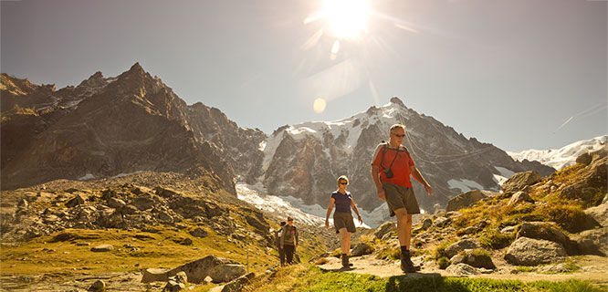 Hikers in bright sun, French Alps, France