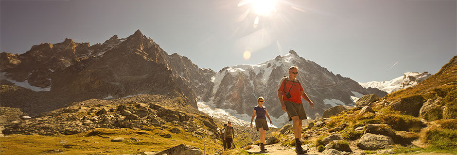 Hikers in bright sun, French Alps, France