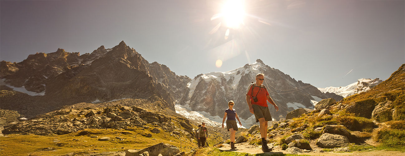 Hikers in bright sun, French Alps, France