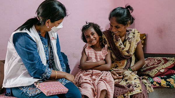 doctors without borders staff talking with child and mother