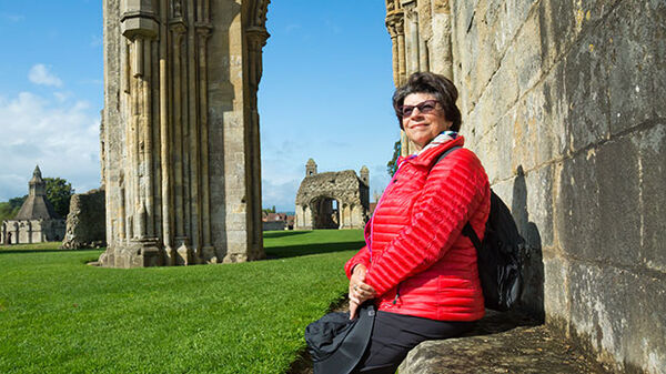 Lady in red at cathedral, Glastonbury, England