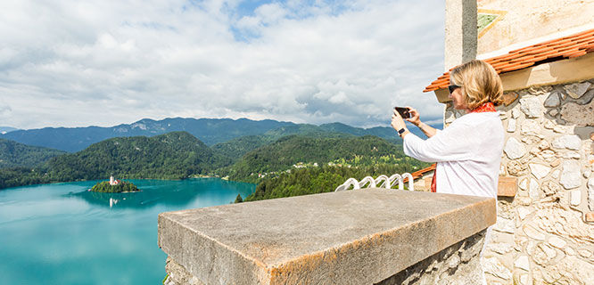 lady-taking-picture-high-above-lake-bled-slovenia
