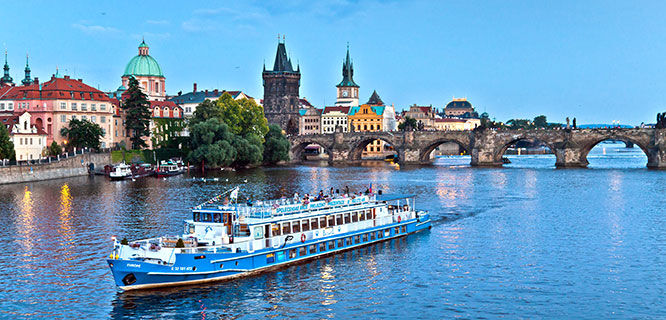 Boat and Charles Bridge on Vltava River, Prague, Czech Republic