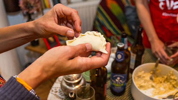 hands-holding-a-pierogi