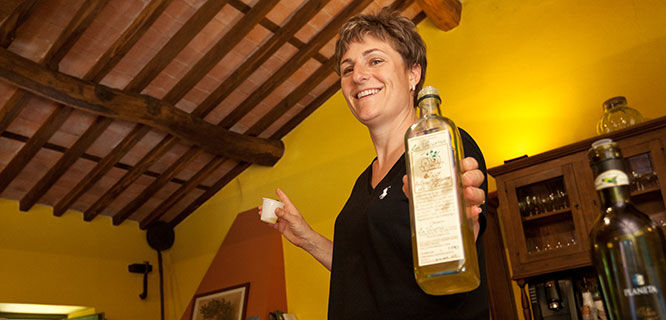 lady holding olive oil bottle