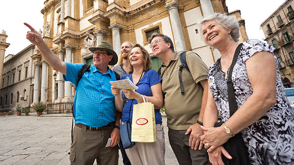 Tour members pointing at a sight, Italy
