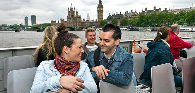 man and woman on a tour boat on the thames river in london