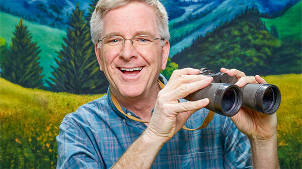 man holding binoculars