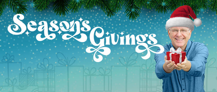 man wearing red stocking cap holding a present