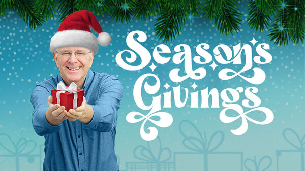 man wearing red stocking cap holding a present