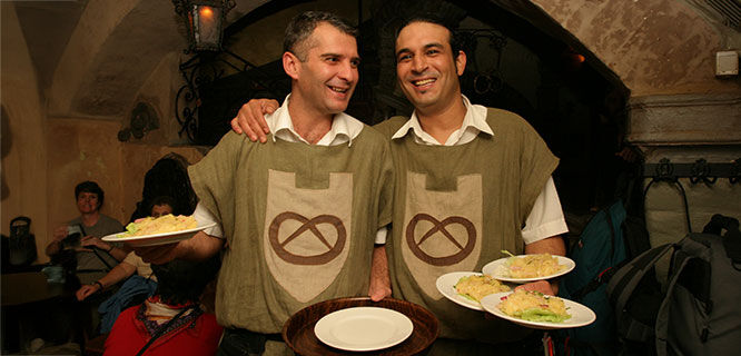 two men serving dinner