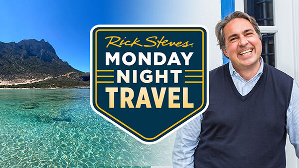 rocky island outcrop with clear blue water and man