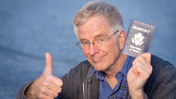 Rick holding passport with thumbs-up