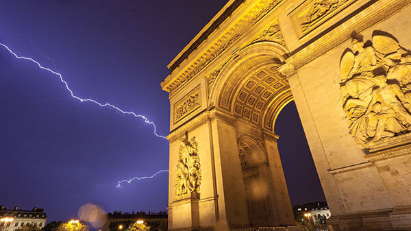 Arc de Triomphe and lightning at night, Paris