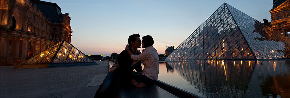 Couple at dusk outside Louvre, Paris, France