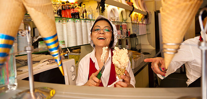 Smiling woman serving gelato, Florence, Italy