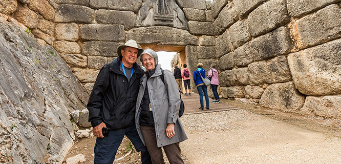 -couple-at-stone-gate-in-mycenae-greece
