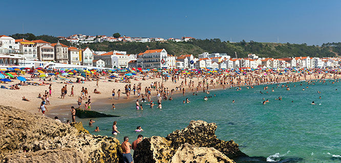 sunbathers-on-nazare-beach-in-portugal