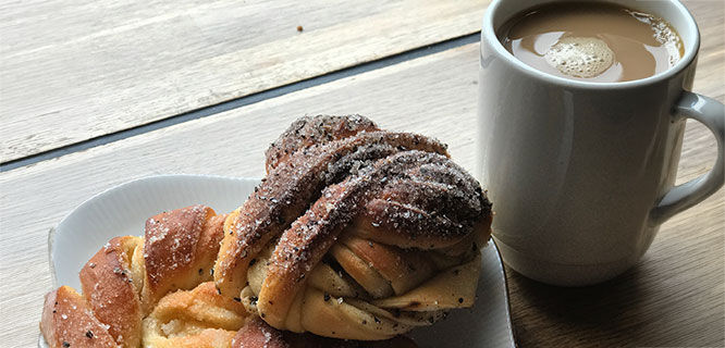 coffee cup and cinnamon bun