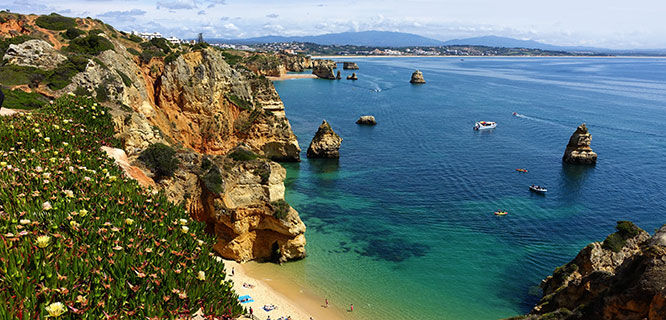 beach and turquoise water in algarve portugal