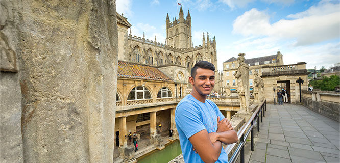 man-leaning-on-railing-in-bath