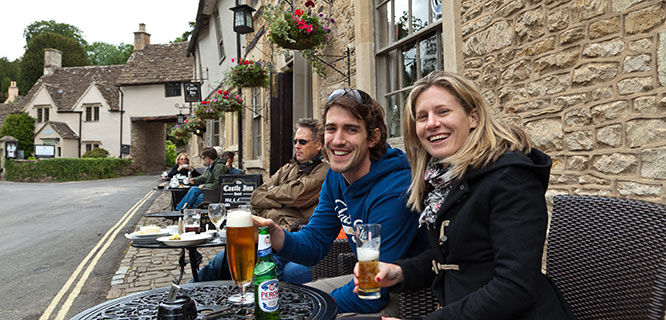 couple drinking beer at a cotswolds cafe