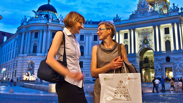 Two smiling women at night, Vienna, Austria 