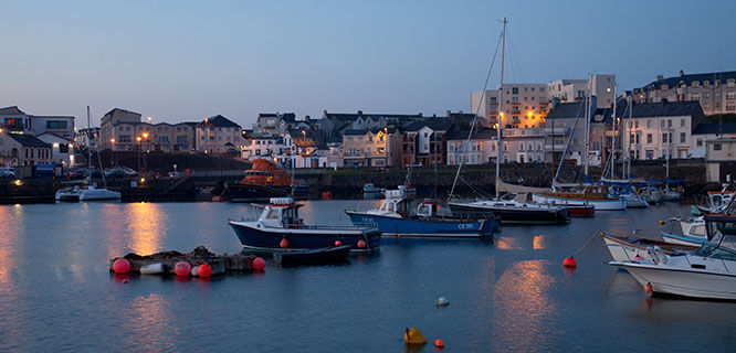 town of portrush harbor at dusk