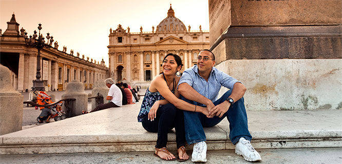 man-and-woman-sitting-in-front of-st-peters-basilica