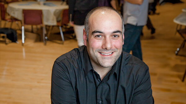 smiling man in black shirt