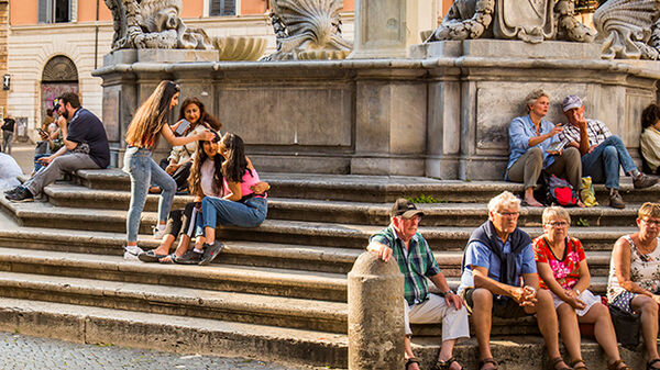 People on steps of fountain, Piazza di Santa Maria, Trastevere, Rome