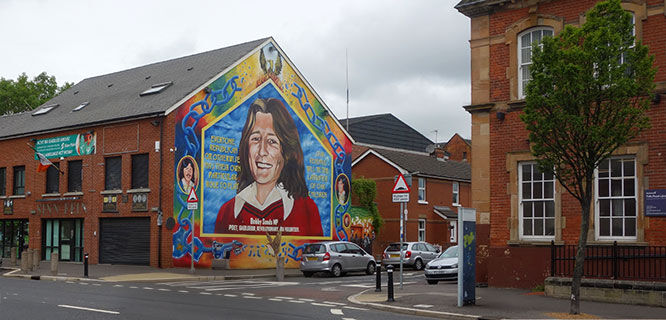 mural-of-a-woman on a birck building in belfast ireland